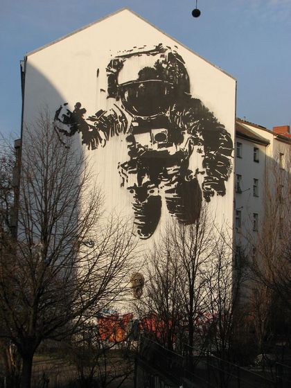 Astronaut schemenhaft an eine Hauswand gemalt