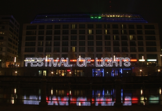 Schriftzug "Festival of Lights" in Leuchtbuchstaben an einem Kanalufer