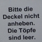 Keramik-Krüge hinter einer Absperrung, Schild "Bitte die Deckel nicht anheben. Die Töpfe sind leer."